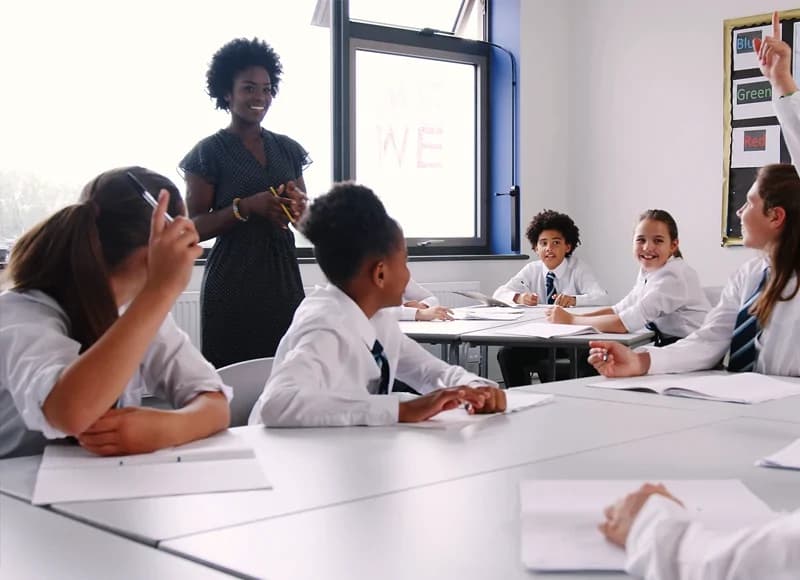 a teacher and some children in a classroom
